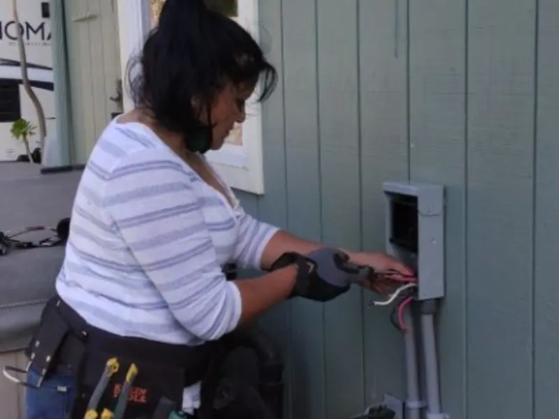 Licensed electrician wiring an exterior subpanel in Eagle Mountain